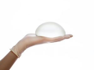 Silicone breast implant on hands